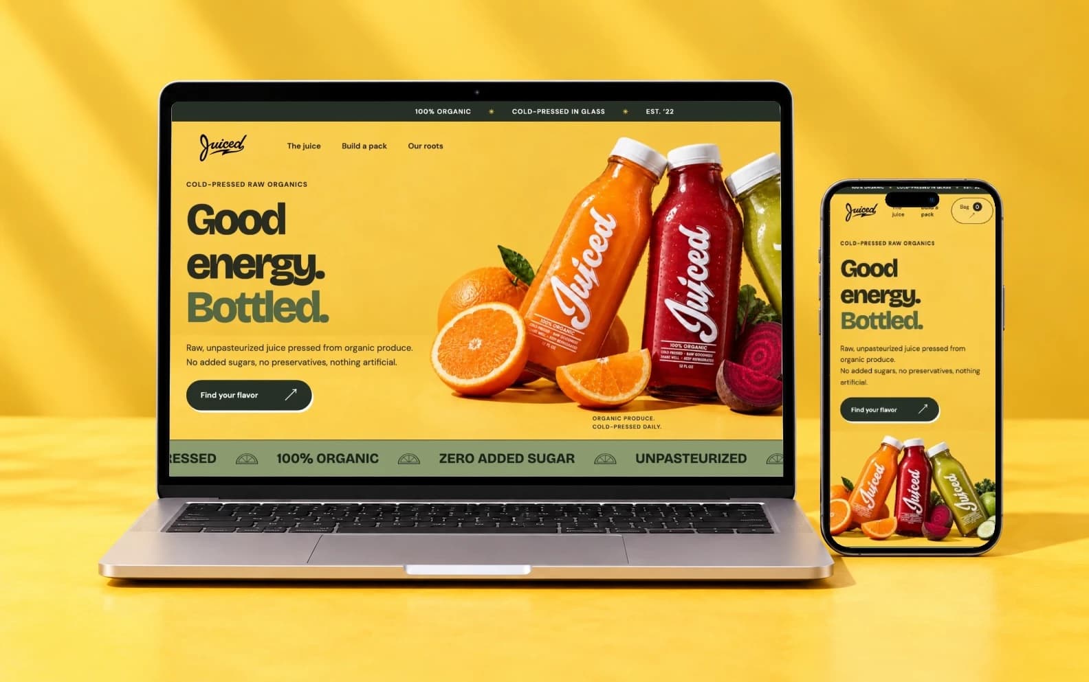 The Juiced concept's homepage on a laptop and a phone against a lemon-yellow backdrop: the headline “Good energy. Bottled.” beside orange, red and green Juiced bottles.